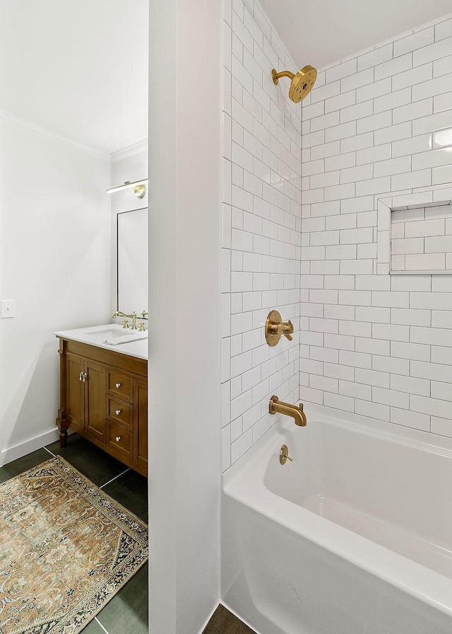 bathroom featuring tile patterned flooring, vanity, and tiled shower / bath