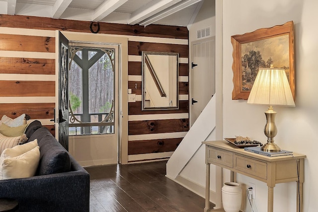 entryway with beamed ceiling and dark hardwood / wood-style floors