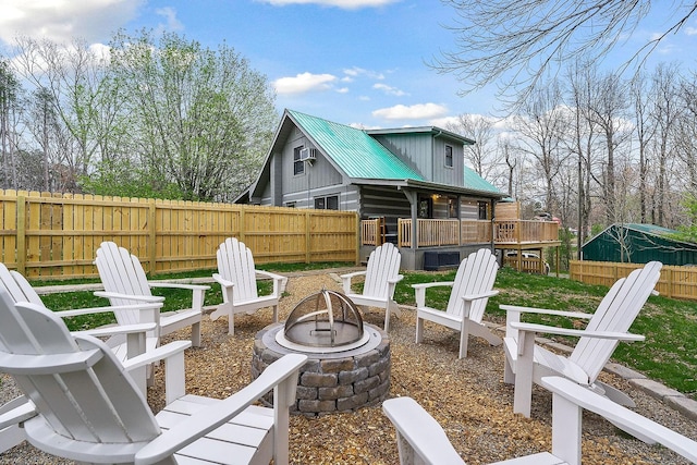 view of patio featuring a deck and an outdoor fire pit