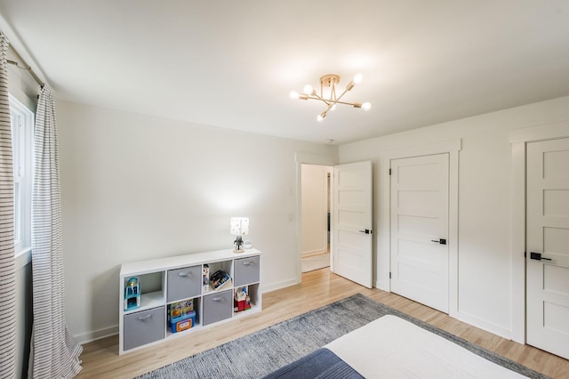 bedroom featuring hardwood / wood-style flooring and a chandelier