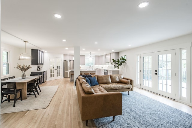 living room featuring light wood-type flooring and french doors