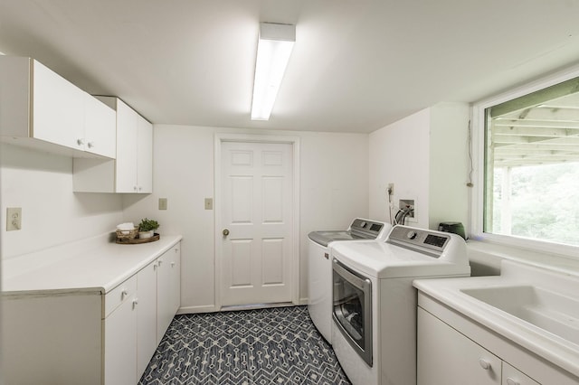 clothes washing area featuring cabinets, independent washer and dryer, and sink