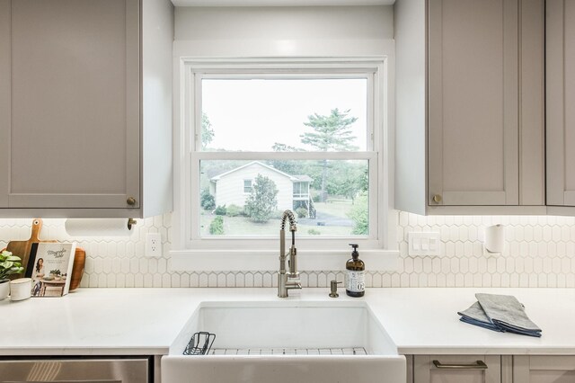 room details featuring tasteful backsplash, gray cabinets, and sink