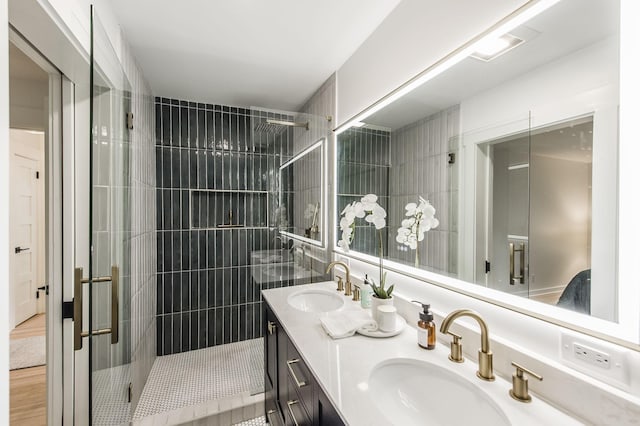 bathroom featuring vanity and a shower with shower door