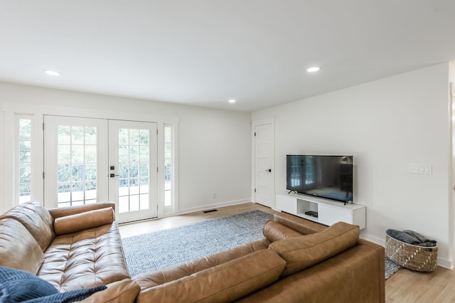 living room with light hardwood / wood-style floors and french doors