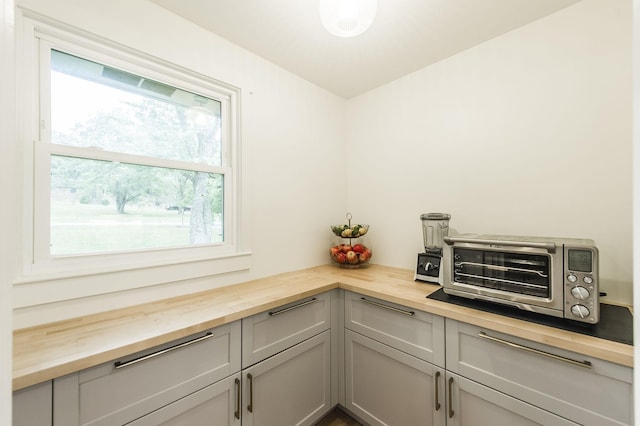 interior space featuring gray cabinetry and wooden counters