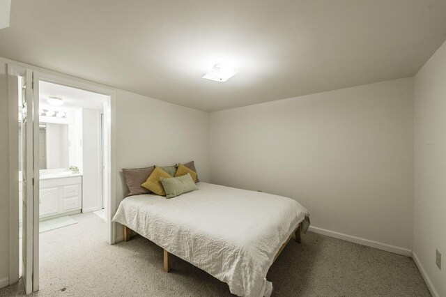 carpeted bedroom featuring ensuite bath