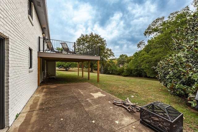 view of yard with a fire pit, a patio area, and a deck