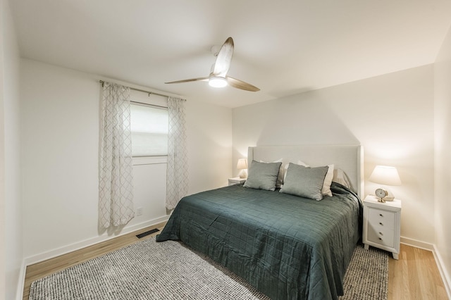 bedroom with light wood-type flooring and ceiling fan