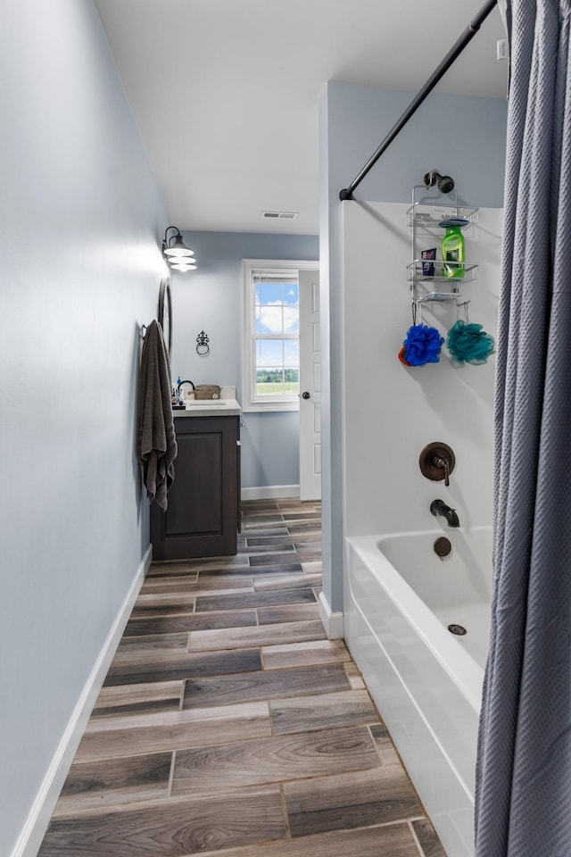 bathroom featuring vanity, wood-type flooring, and shower / tub combo