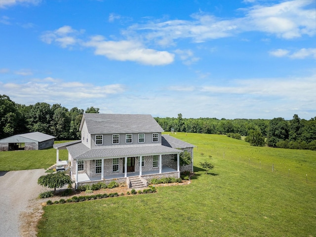 view of front of house with covered porch and a front yard