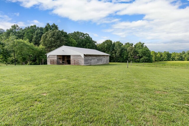 view of yard with a rural view and an outdoor structure