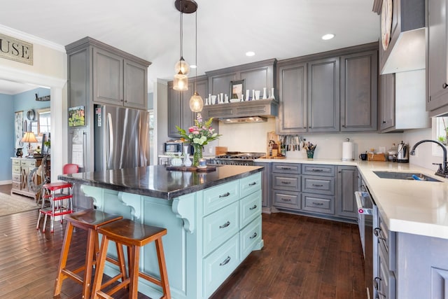 kitchen with dark hardwood / wood-style flooring, stainless steel fridge, a center island, and sink