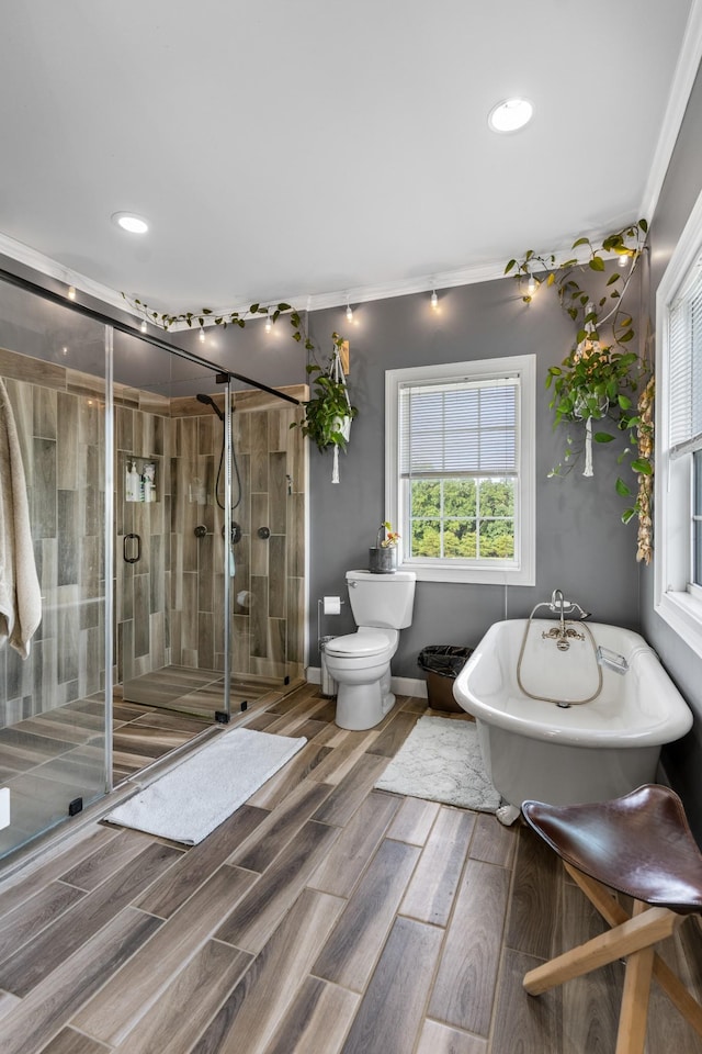 bathroom featuring plus walk in shower, toilet, and ornamental molding