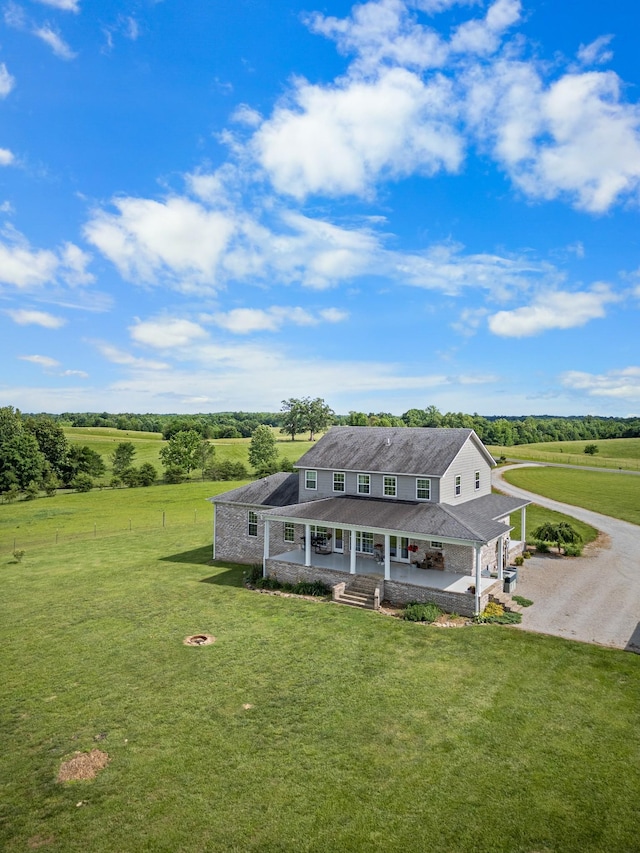 view of front of house featuring a porch, a rural view, and a front lawn