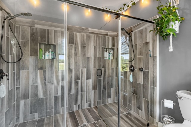 bathroom featuring toilet and walk in shower