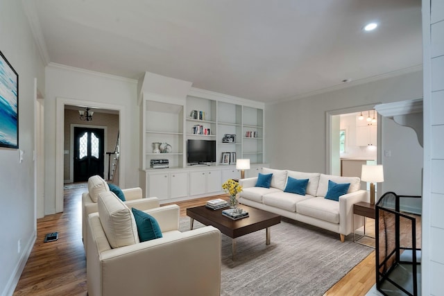 living room with light wood-type flooring and crown molding