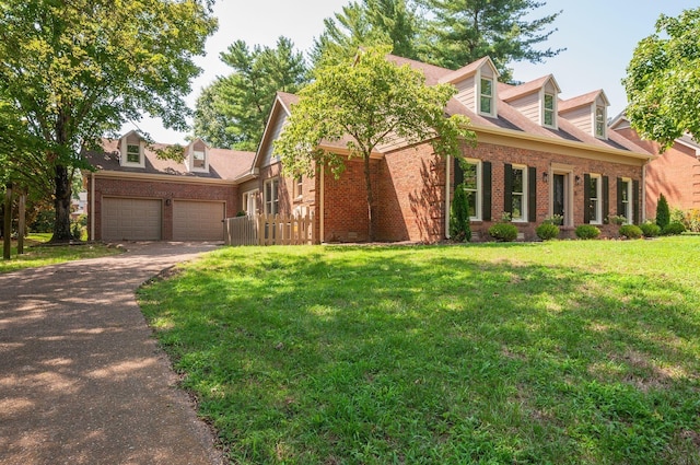 cape cod house featuring a front lawn and a garage