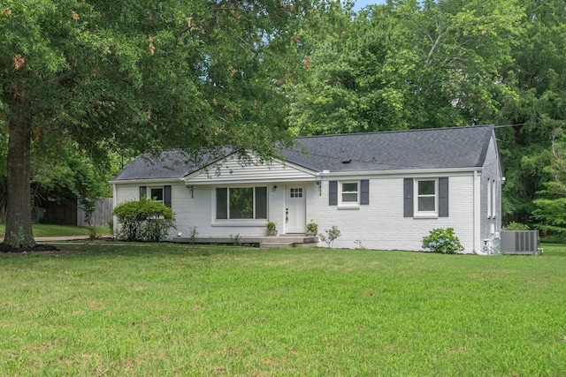 ranch-style house featuring central AC and a front lawn