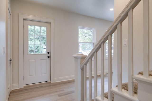 entrance foyer featuring plenty of natural light and light hardwood / wood-style floors