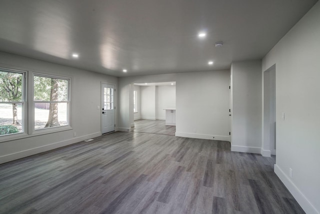 unfurnished living room featuring wood-type flooring