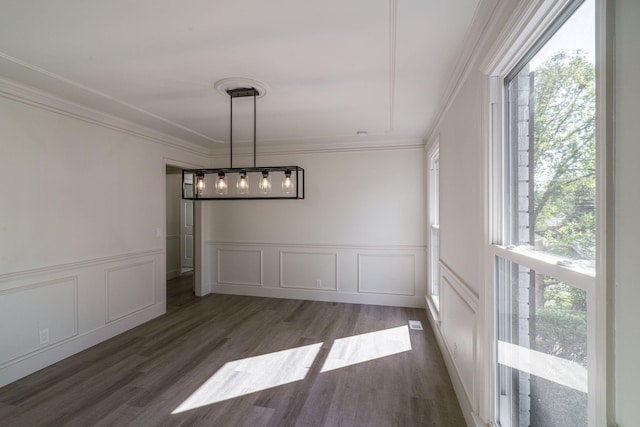 unfurnished dining area featuring dark hardwood / wood-style flooring and ornamental molding