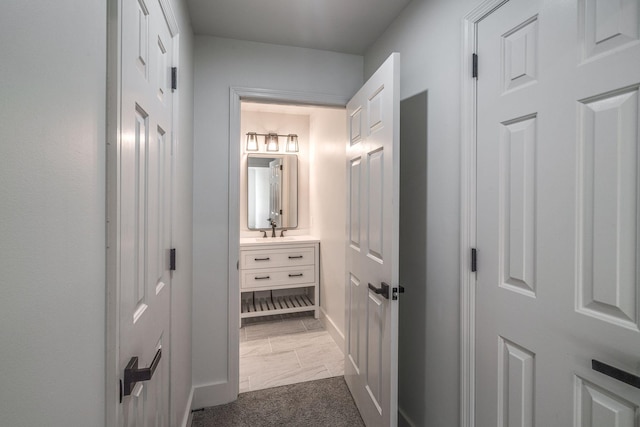 corridor with sink and carpet floors