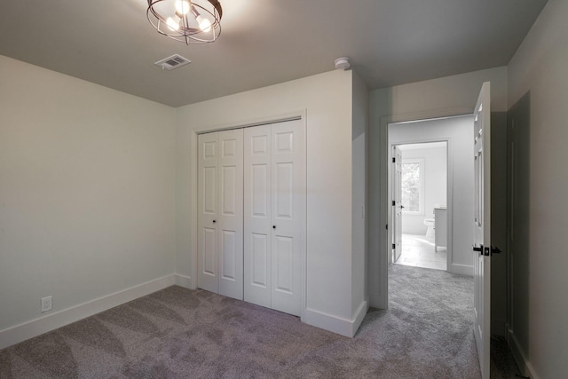 unfurnished bedroom with carpet floors and a closet