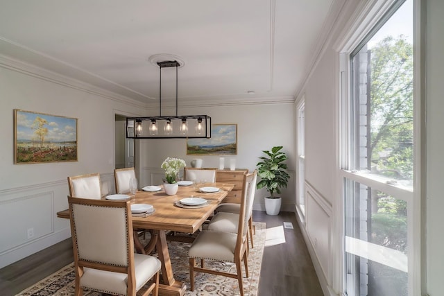 dining space with dark hardwood / wood-style floors and crown molding