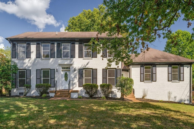 colonial home with cooling unit and a front lawn