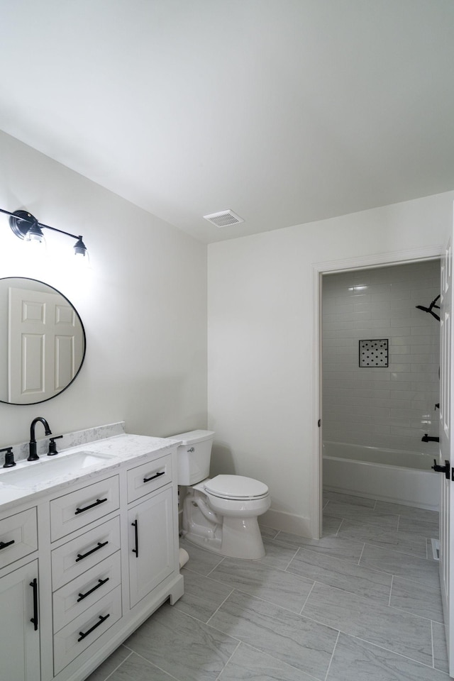 full bathroom with vanity, tiled shower / bath combo, and toilet