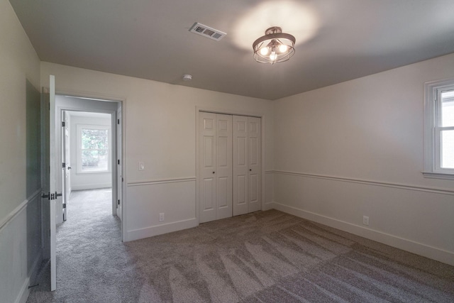 unfurnished bedroom with a closet and carpet