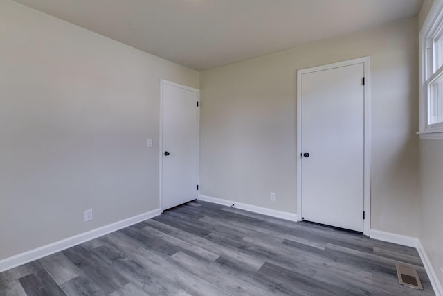 unfurnished room featuring dark hardwood / wood-style flooring