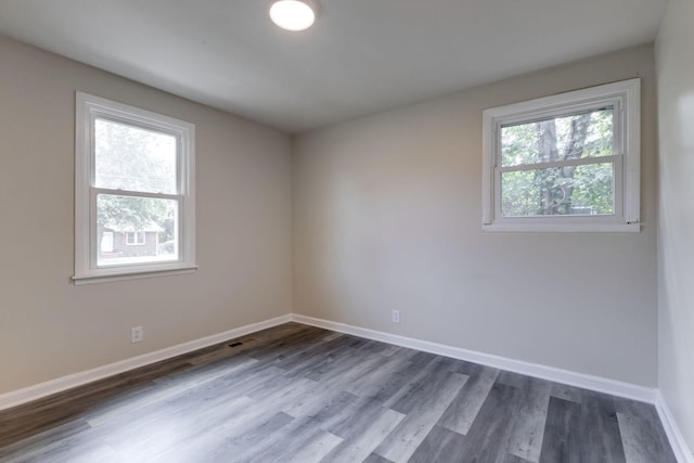 spare room with dark hardwood / wood-style flooring