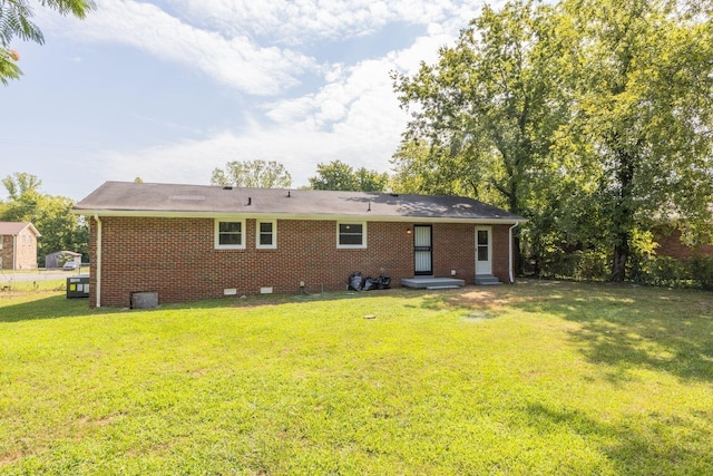 rear view of property with a yard