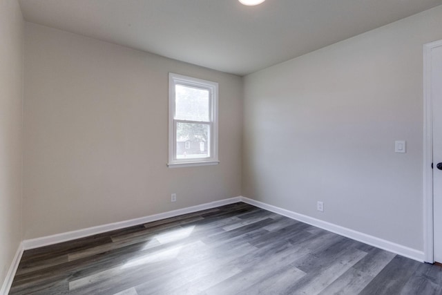 unfurnished room with dark hardwood / wood-style floors