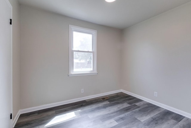 empty room featuring dark hardwood / wood-style flooring