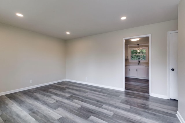 empty room with dark wood-type flooring and sink