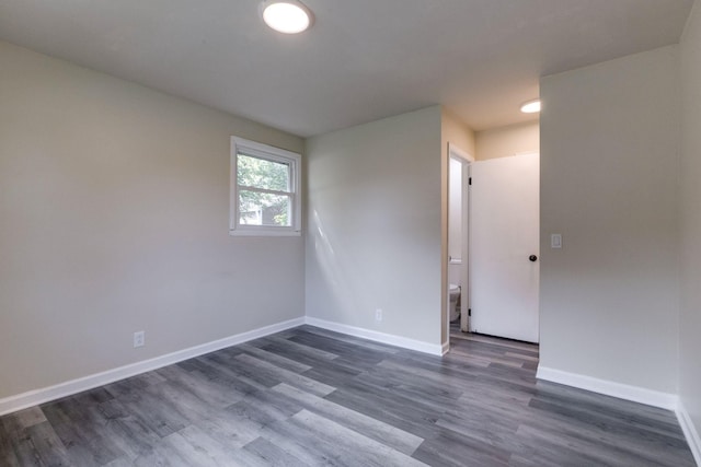 empty room with dark hardwood / wood-style floors