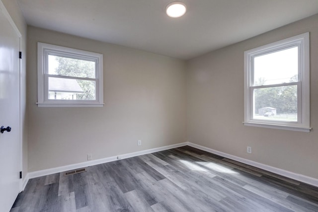 spare room with hardwood / wood-style floors