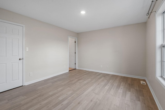 unfurnished room with light hardwood / wood-style flooring