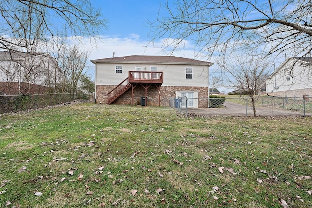 back of house featuring a yard and a wooden deck