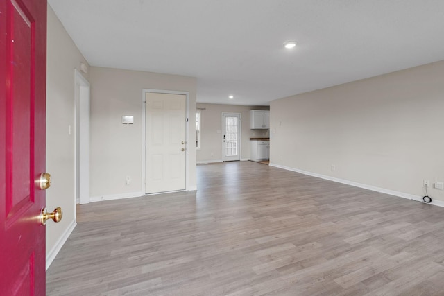 unfurnished living room featuring light wood-type flooring