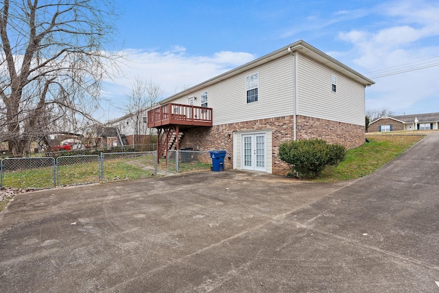 back of property featuring a wooden deck and french doors