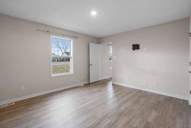 spare room featuring light wood-type flooring