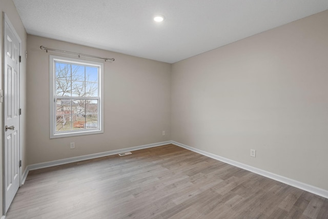 empty room with light hardwood / wood-style floors