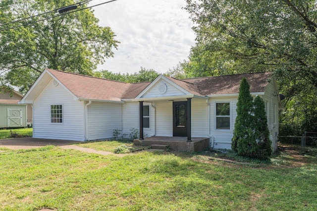 single story home with a front lawn and covered porch