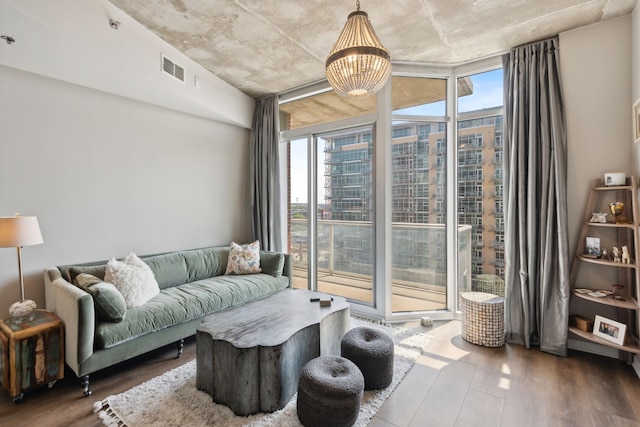 living room with floor to ceiling windows and dark wood-type flooring