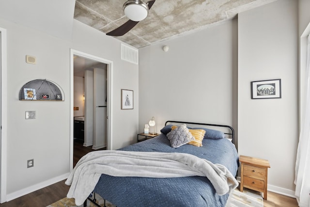 bedroom with dark hardwood / wood-style floors and ceiling fan