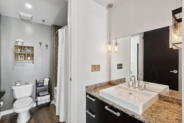 bathroom featuring hardwood / wood-style flooring, vanity, and toilet